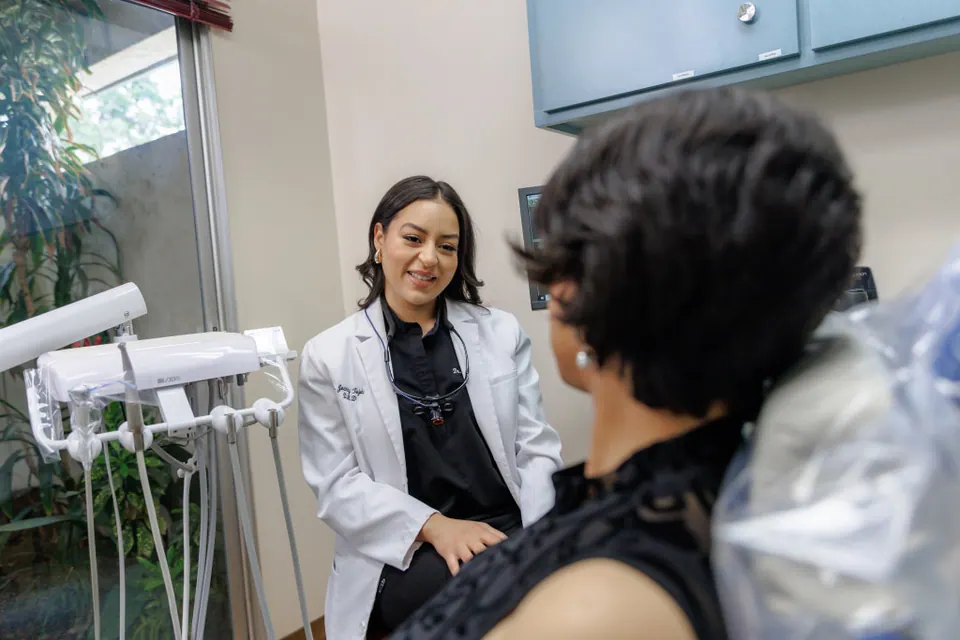 Patient at a first dental visit talking with the dental team